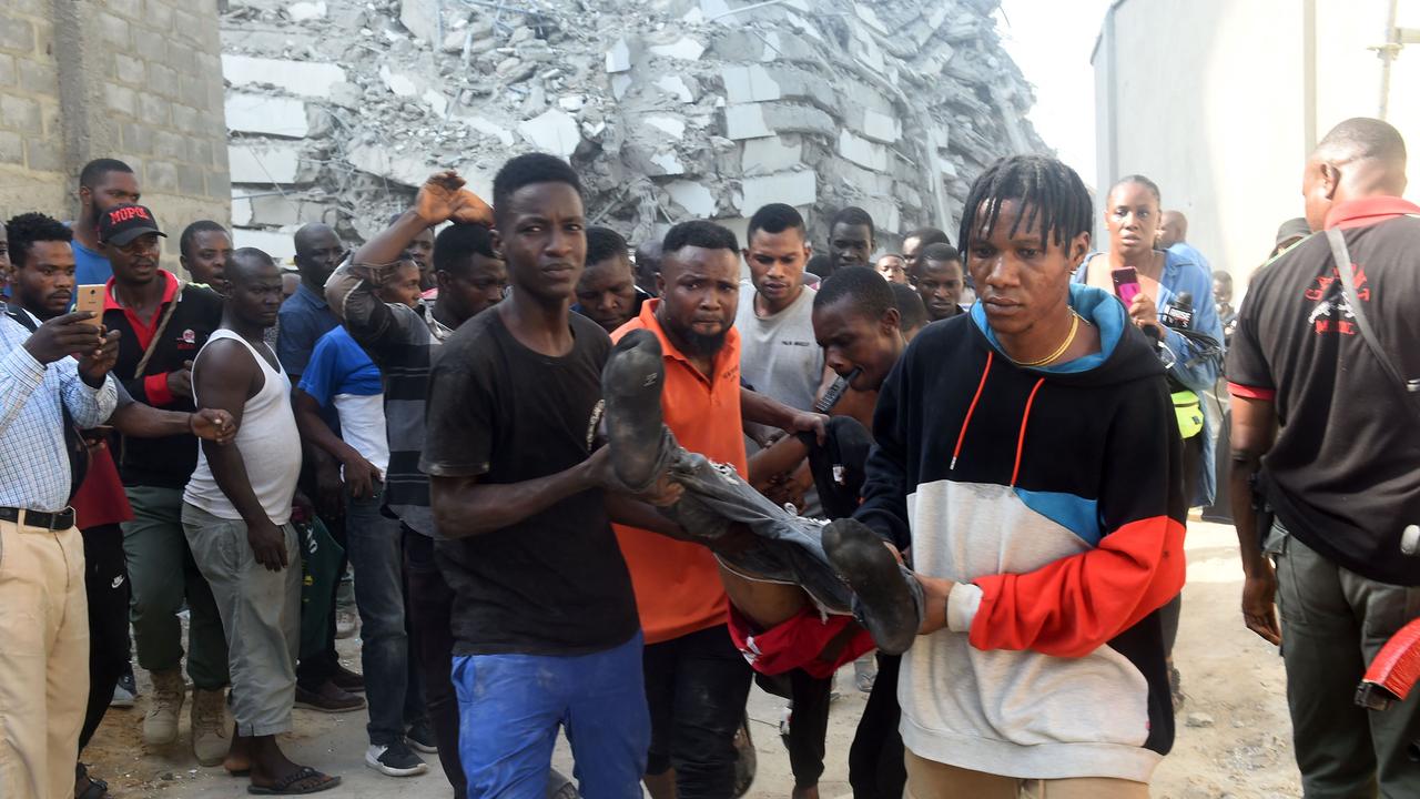 A deceased worker is pulled out from the rubble of a building under construction that collapsed at Ikoyi district of Lagos.