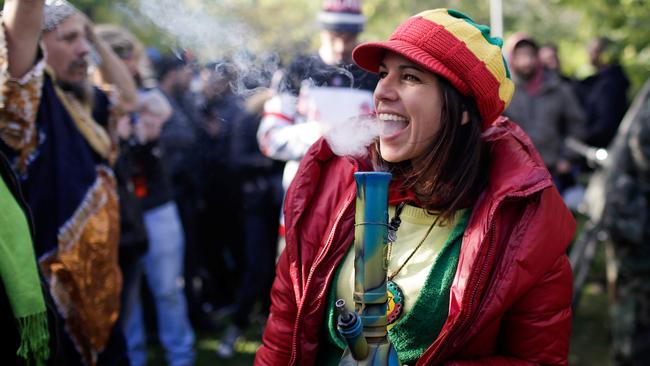 A woman smokes a bong in Toronto on October 17, the day Canada legalised recreational marijuana. Picture: REUTERS/Carlos Osorio