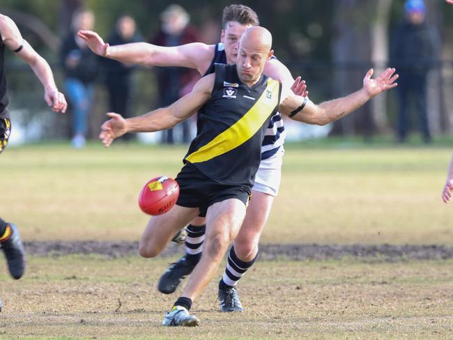 Damien Rayson boots Seaford forward. Pic: Doug Farr