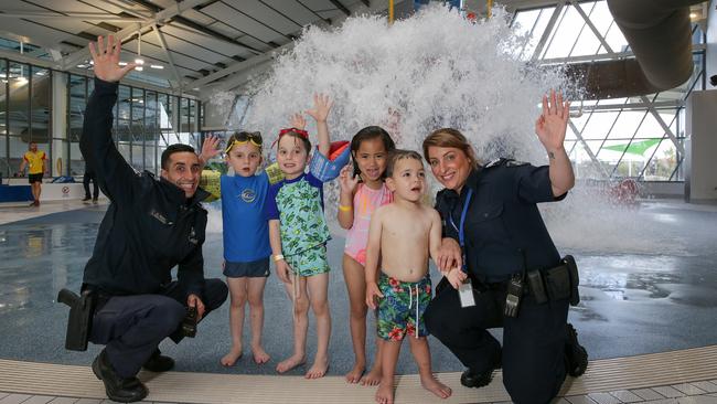 Senior Constable Andrew Bosco with local kids George, Leonidas, Leezyl, Zane and Acting Sergeant Rebecca Amiridis at Splash Aqua Park and Leisure Centre. Picture: George Salpigtidis