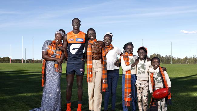 Leek Aleer, with his mother Tabitha and sisters Agot, Athok, Lueth, Yar and Ajah, will make his AFL debut for the Giants on Saturday. Picture: Phil Hillyard