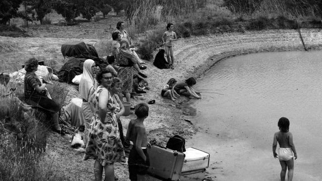 Mothers and their children waiting grimly at a dam at Five Ways Crossroads, Warrandyte South.