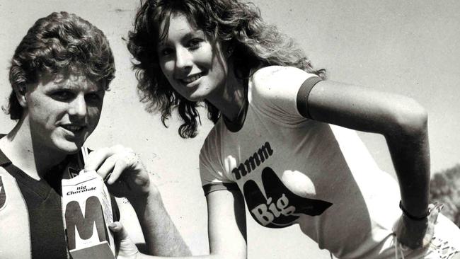 Hawthorn's Dermott Brereton helps Caroline Murias promote Big M in 1983.