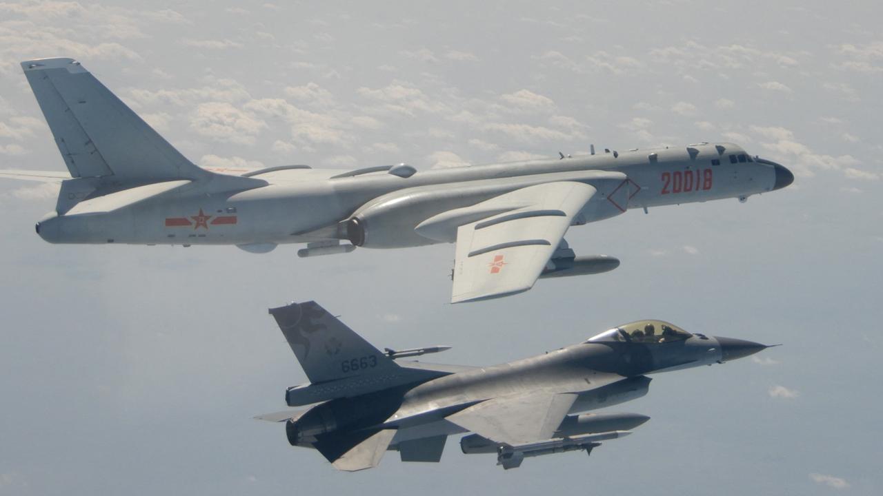 A Taiwanese F-16 fighter jet flying next to a Chinese H-6 bomber (top) off the coast of Taiwan. (Photo by Handout / Taiwan's Defence Ministry / AFP)