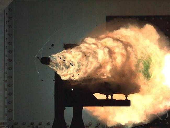 A photo of the moment a shell leaves the barrel of a US navy electromagnetic rail gun that can fire projectiles at 8700km/h — without the aid of gunpowder.