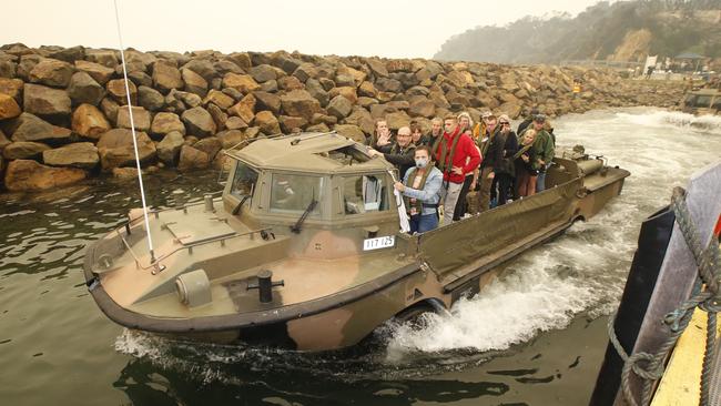 The first of the passengers are loaded on to the landing boats by ADF personal. Picture: David Caird