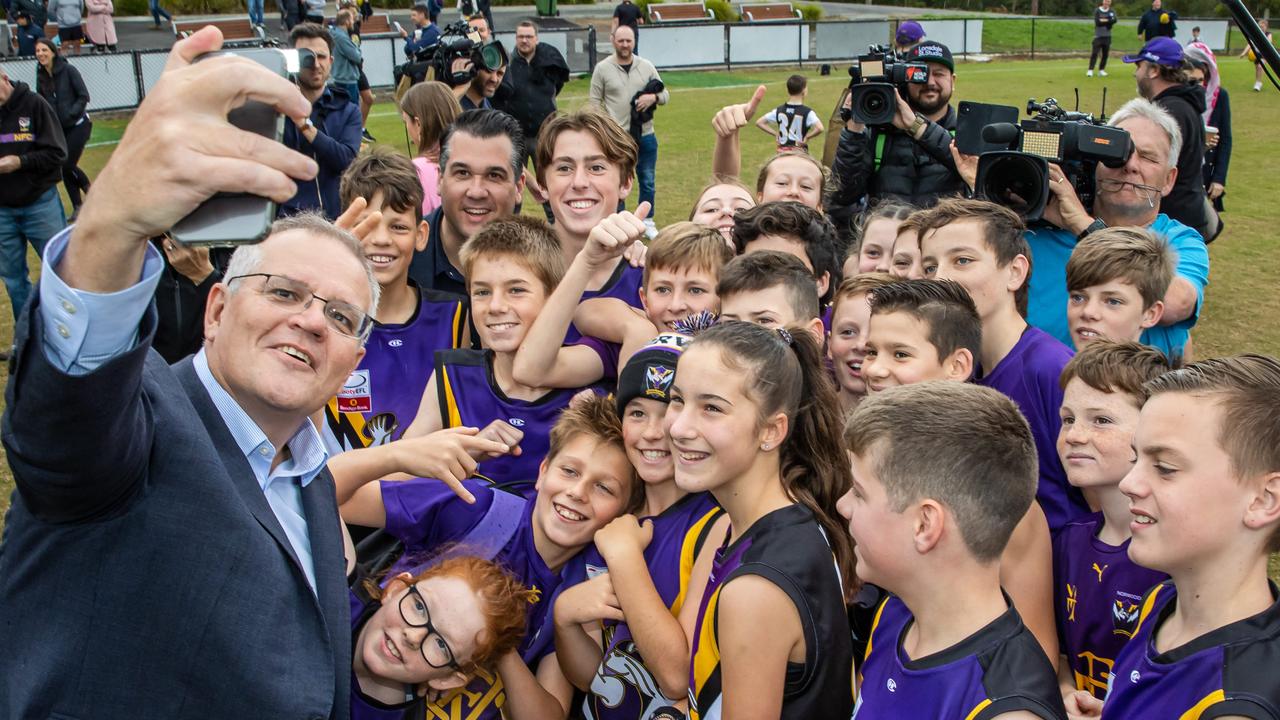 Scott Morrison grabs a selfie while visiting Norwood Sporting Club in Ringwood VIC to meet with juniors (under 14s and under 12s). Picture: Jason Edwards