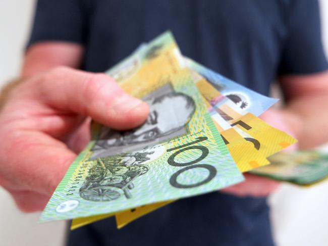 A man handing out Australian dollar bills. A picture that describes buying, paying, handing out money, or showing money.