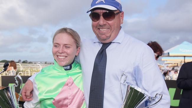 Jockey Tiffani Brooker (left) celebrates with trainer Darryl Hansen, after riding Monsieur Gustave to win race number 8, The SUA George Moore Stakes, Doomben Racecourse, Brisbane, Saturday, December 2, 2017. (AAP Image/Jono Searle)