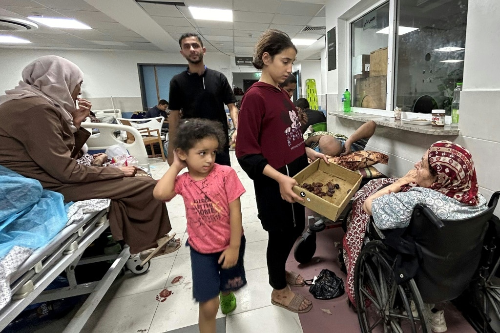 Crowds of people have crammed into the corridors of Al-Shifa hospital to escape the fighting in Gaza between Israel and Hamas