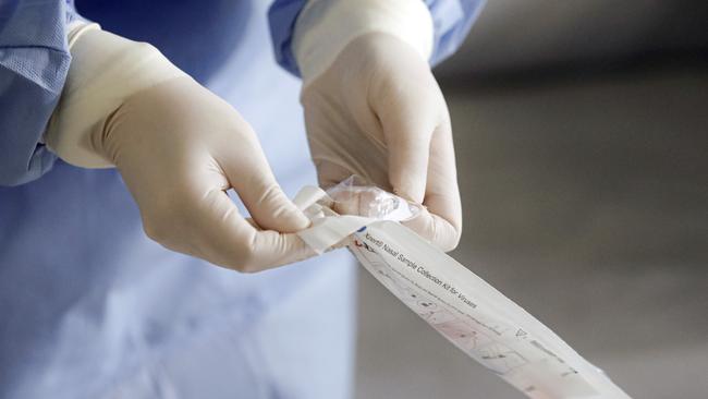 A health official prepares to take samples for a coronavirus test. Picture: AP/George Calin