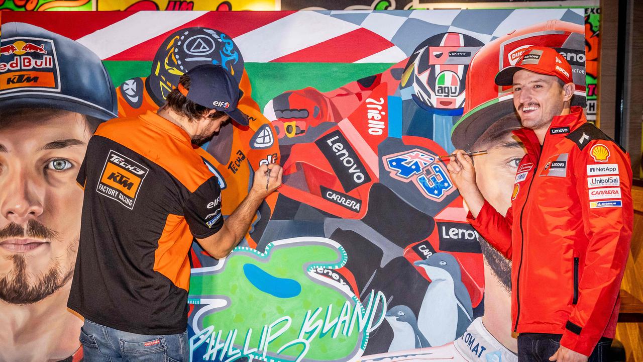 Miller and Gardner putting the finishing touches on a GP artwork. Picture: Jake Nowakowski