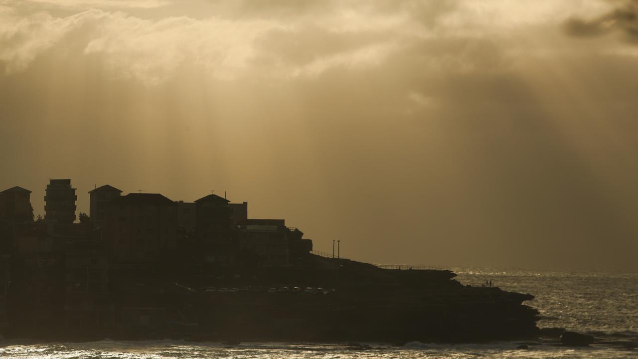 Sunrise as huge seas bash Bondi on Thursday morning. Picture: John Grainger