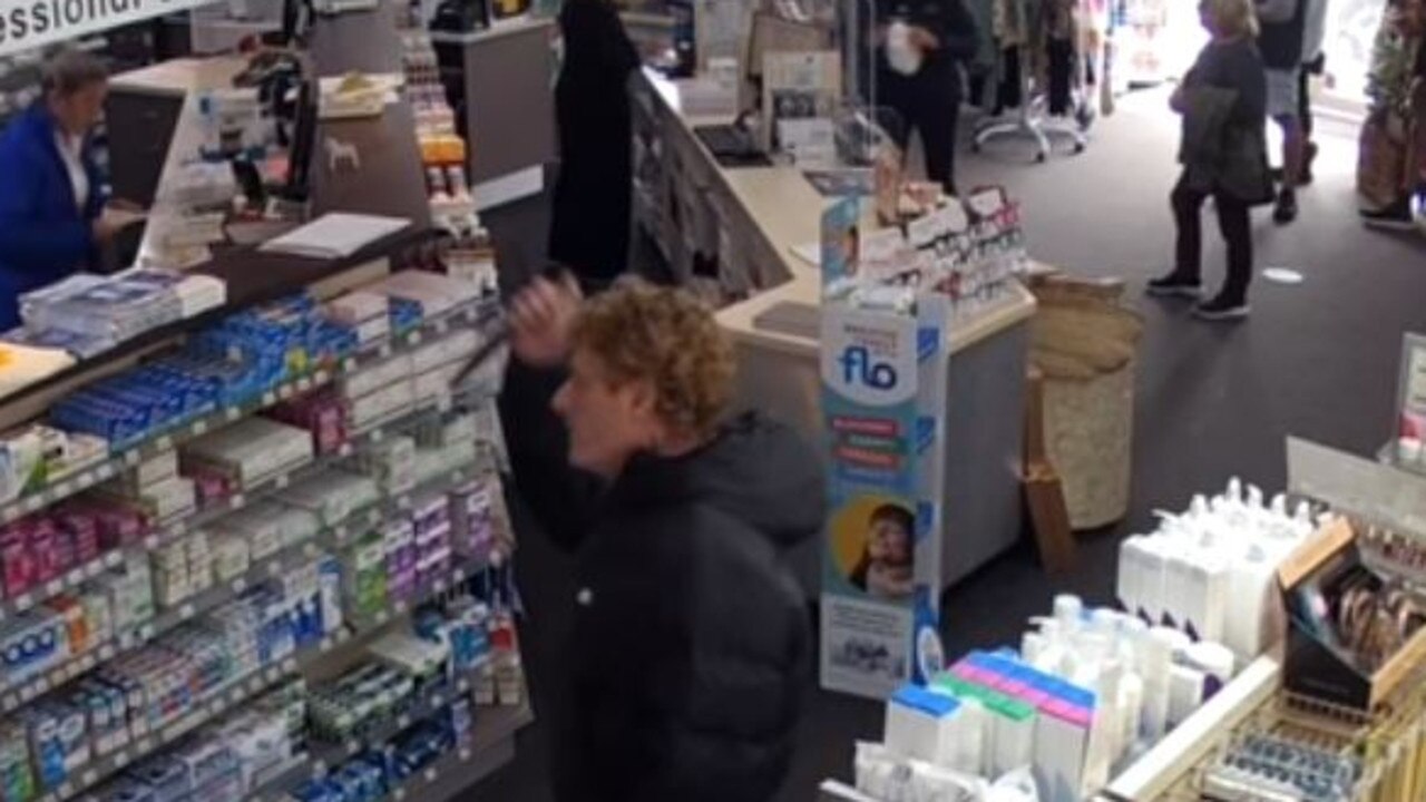 The man can be seen pulling a knife inside the Torquay store.