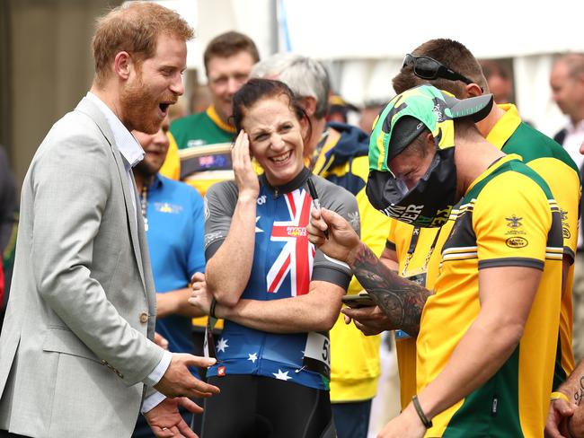 Prince Harry meets Australian athlete Ben Yeomans as he wears a pair of Budgy Smugglers on his head. Picture: Getty