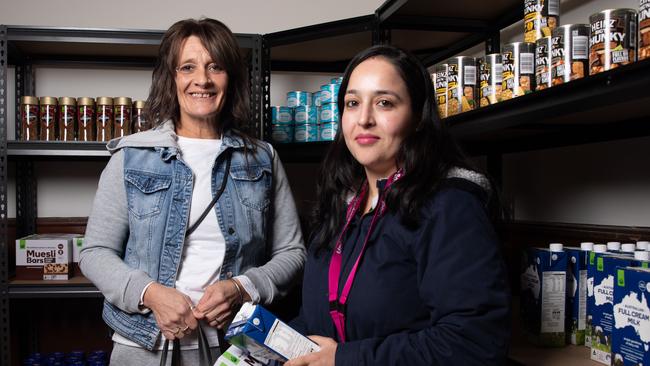 Julia Flockhart receiving items from Emergency Relief officer Jasdeep Kaur as part of an appeal for winter donations at Uniting Church Hobart. Picture: Linda Higginson