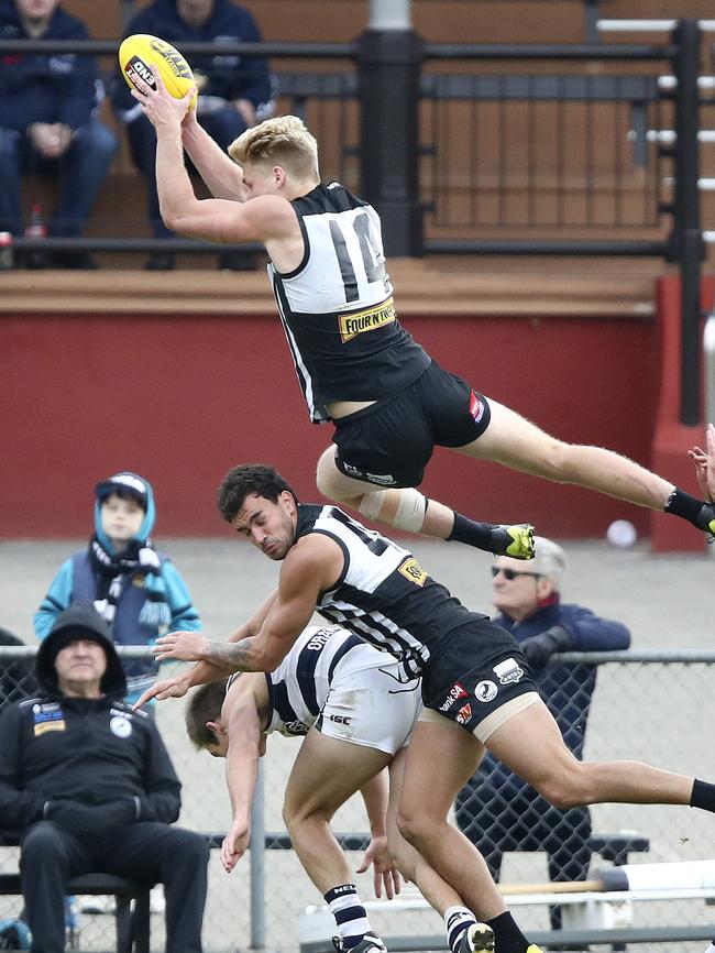 Billy Frampton takes a screamer over former Port team mate Brendon Ah Chee in the SANFL last year. Picture Sarah Reed