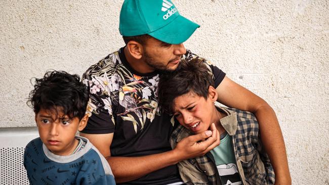 A family mourns the death of people killed in overnight Israeli bombardment in Gaza. Picture: AFP.