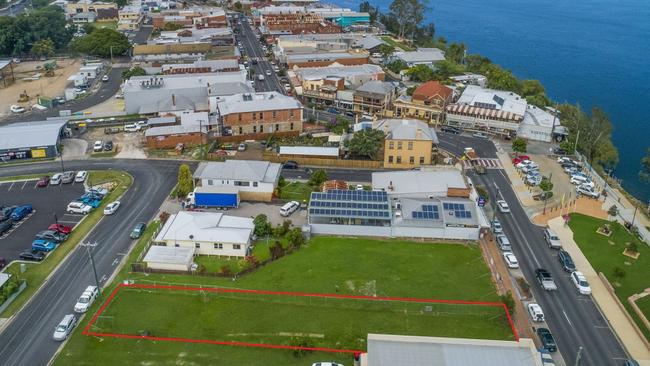 An aerial showing the Maclean CBD, with the block of land sold at the bottom in red,