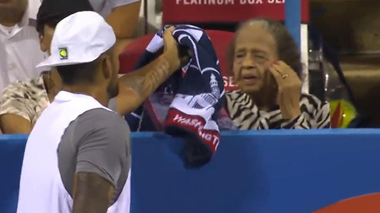 Nick Kyrgios gifts a towel to a fan.