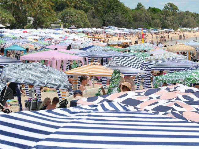 Holiday Crowds pack in at Noosa Main Beach. Picture Lachie Millard