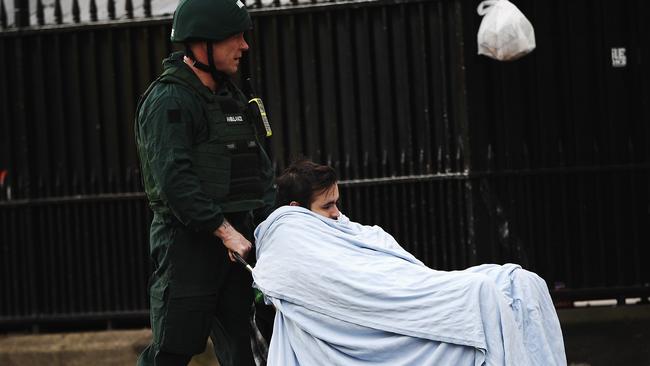 A member of the public is taken away for treatment by emergency services medic near Westminster Bridge and the Houses of Parliament on March 22, 2017 in London. Picture: Carl Court/Getty Images