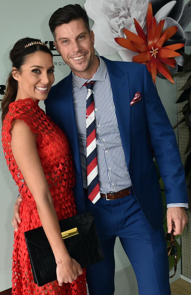 The Bachelor Sam Wood (right) and Snezana Markoski pose for photos in the Birdcage on Melbourne Cup Day at Flemington Racecourse. Picture: AAP Image/Julian Smith