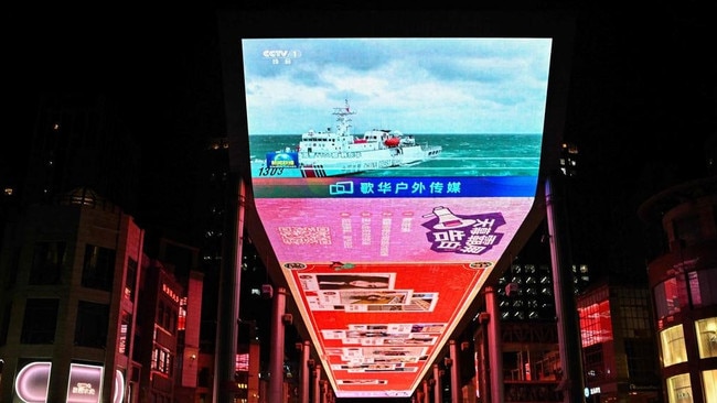 A public big screen broadcasts news about China's military drills around Taiwan, outside a shopping mall in Beijing in April. Picture: AFP