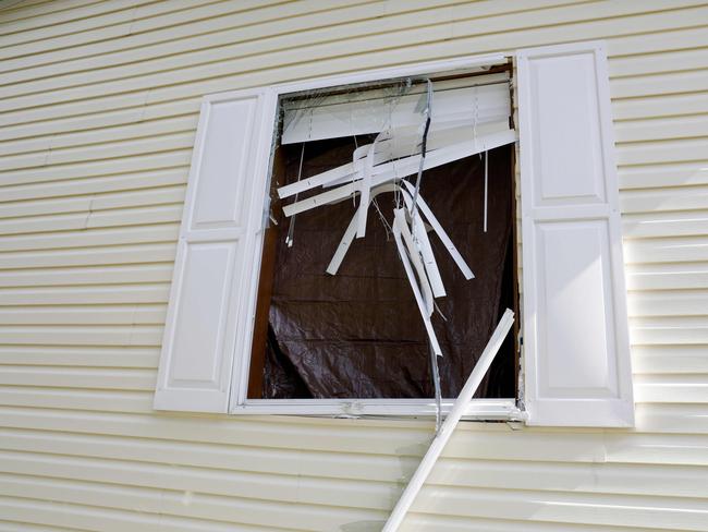 A broken window is seen on a home the FBI searched in connection with a plot to kidnap Michigan Governor Gretchen Whitmer. Picture: AFP