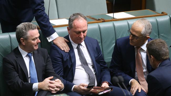 Scott Bucholz pats  Deputy PM Barnaby Joyce on the shoulder during a vote on a censure motion brought on by Labor to censure the Deputy PM Barnaby Joyce, in the House of Representatives Chamber at Parliament House in Canberra. Picture Kym Smith