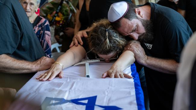 A family grieves during the funeral at the Hod Ha'sharon cemetery in Israel.