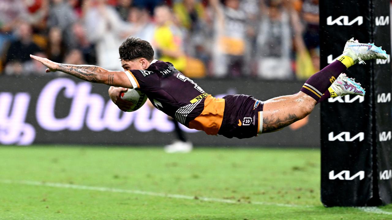 Reece Walsh flies over the line against the Cowboys.