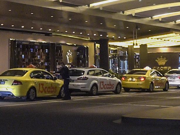 Taxis queue for customers outside the Crown Melbourne casino and entertainment complex at night in Melbourne, Australia, on Wednesday, March 24, 2021. A Royal Commission, an independent inquiry that determines Crown Resorts Ltd.'s fitness to run its flagship Melbourne casino, started today. Photographer: Carla Gottgens/Bloomberg via Getty Images