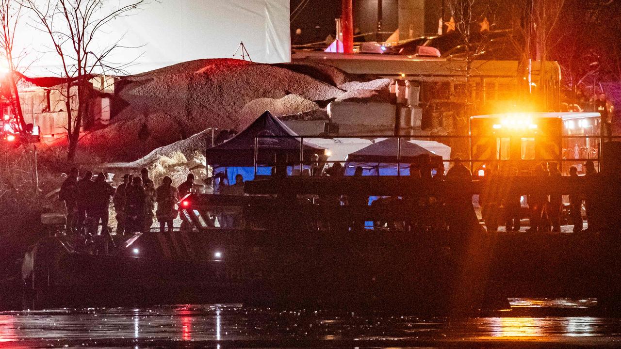 Emergency response units conduct search and rescue operations in the Potomac River.