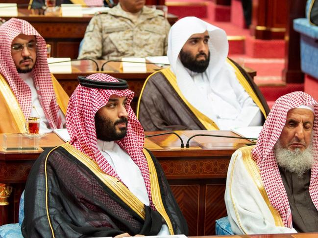 In this photo provided by the Saudi Press Agency, SPA, Crown Prince Mohammed bin Salman, front row on left, seated next to the countryâ€™s most senior cleric, listens to Saudi King Salman give his annual policy speech in the ornate hall of the consultative Shura Council, Monday, Nov. 19, 2018, Riyadh, Saudi Arabia. Salman gave his first major speech since the killing of journalist Jamal Khashoggi by Saudi agents, expressing support for his son, the crown prince, and making no mention of the accusations that the prince ordered the killing. Mondayâ€™s speech highlighted the kingdomâ€™s priorities for the coming year, focusing on issues such as the war in Yemen, security for Palestinians, stability in the oil market, countering rival Iran and job creation for Saudis.  (AP Photo/Saudi Press Agency)