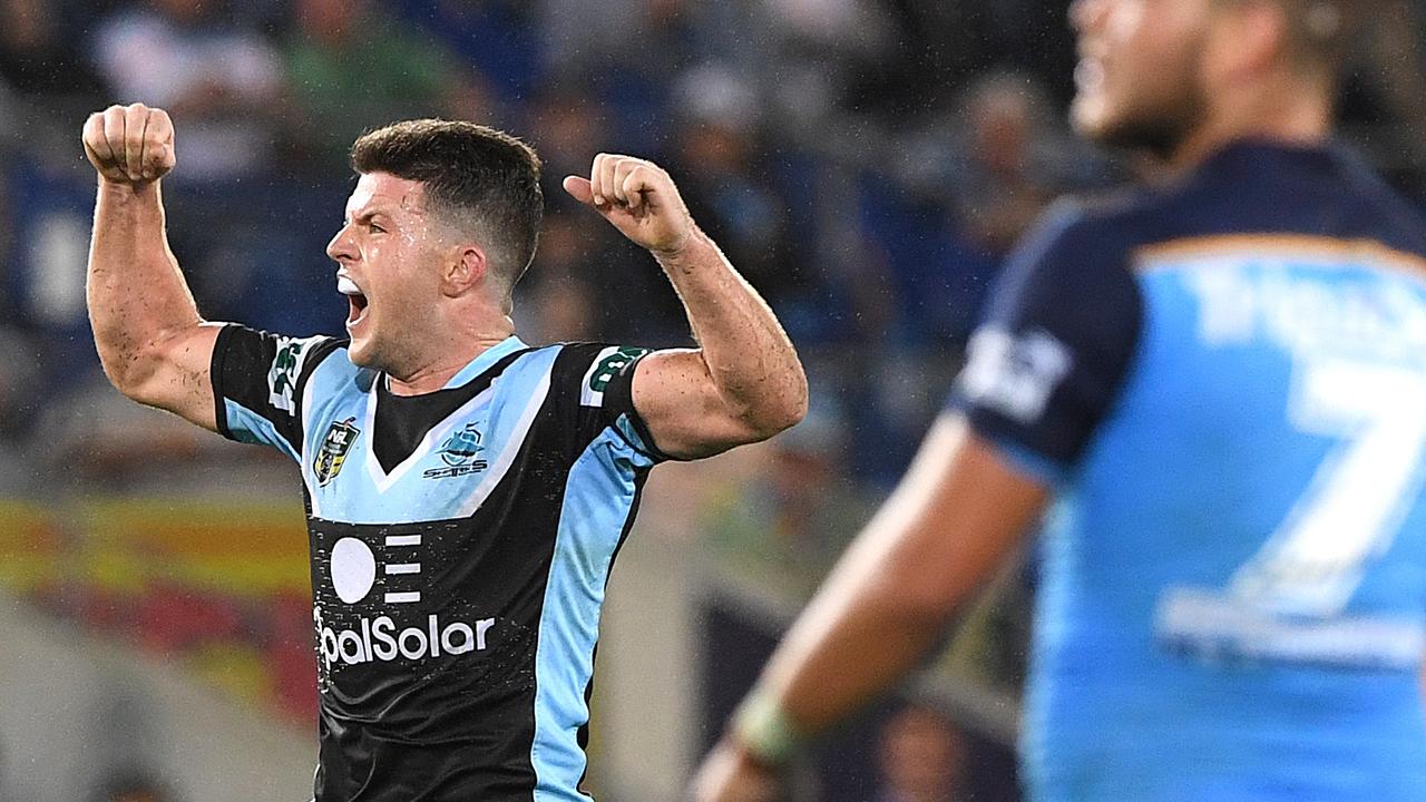 Cronulla halfback Chad Townsend celebrates the matchwinning field goal as Titans opposite Ash Taylor watches on. Photo: Dave Hunt
