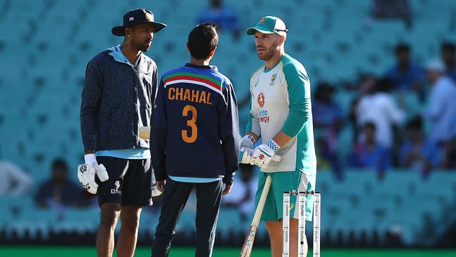 SYDNEY, AUSTRALIA - DECEMBER 08: Aaron Finch of Australia speaks to Hardik Pandya and Yuzvendra Chahal of India before game three of the Twenty20 International series between Australia and India at Sydney Cricket Ground on December 08, 2020 in Sydney, Australia. (Photo by Ryan Pierse/Getty Images)