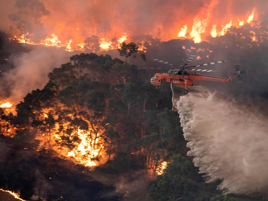 A helicopter fighting a bushfire near Bairnsdale in Victoria's East Gippsland region. Pic: AFP