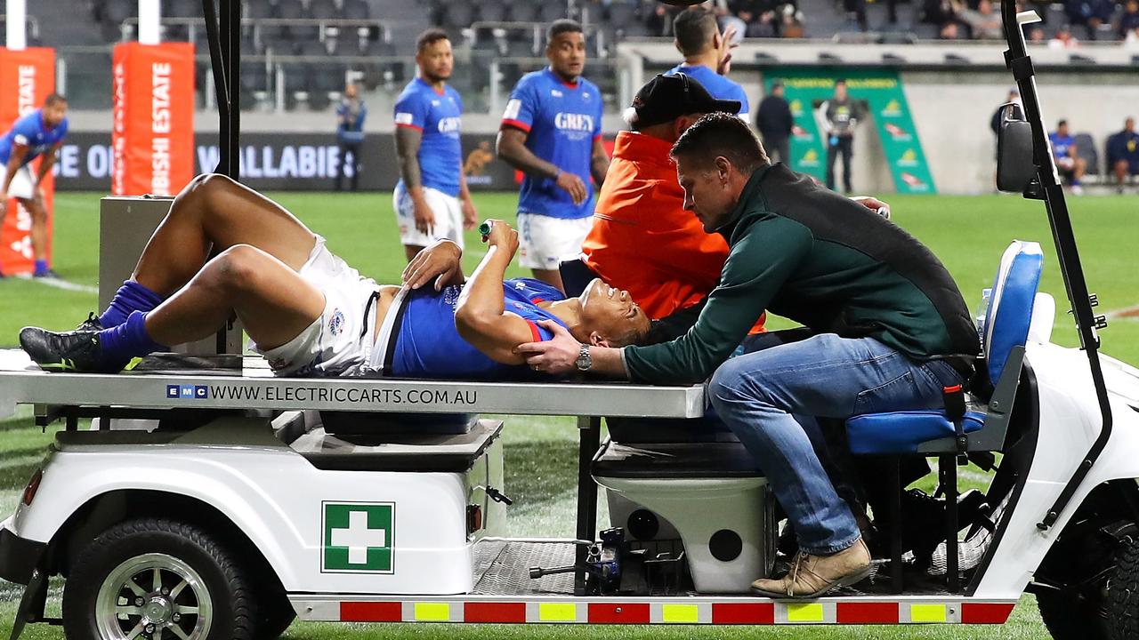 Scott Malolua of Samoa is taken from the field on a medicab at Bankwest Stadium.