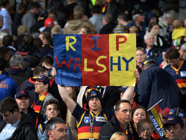 Crows fans pay tribute to Phil Walsh after his violent death.