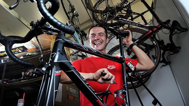 Team Lotto Belisol mechanic Steven Von Olmen working on the tour riders' bikes in the village at Victoria Square...