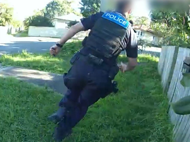 A police officer runs to intercept a teenager accused of a series of break-ins across Brisbane.