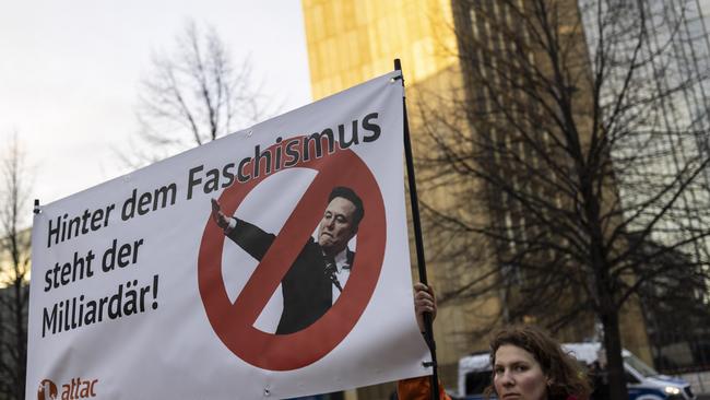 Protesters outside the WELT Economy Summit hold up a placard that reads "Behind fascism is a billionaire", critisizing tech billionaire Elon Musk on January 27, 2025 in Berlin, Germany. Picture: Maja Hitij/Getty Images