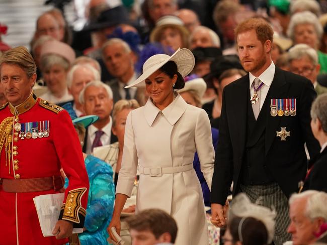 Prince Harry and Meghan enter the cathedral under the watchful eye of the 200-strong crowd. Picture: Getty Images