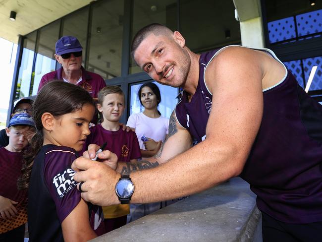 Cory Paix signs an autograph for Elsie Kal 8 at Broncos training at Red Hill. Picture: Adam Head