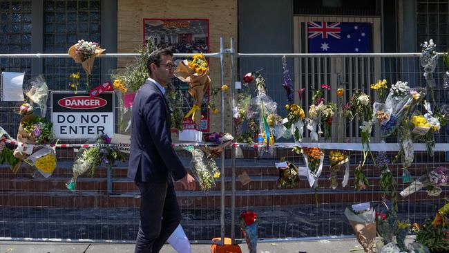 Member of Parliament Josh Burns walks past the damaged Adass Israel Synagogue on December 10. Picture: Asanka Ratnayake/Getty Images