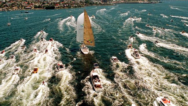 Brindabella, surrounded by spectator craft, approaches finish line as it sails up the Derwent River to take line honours in the 1997 Sydney to Hobart.