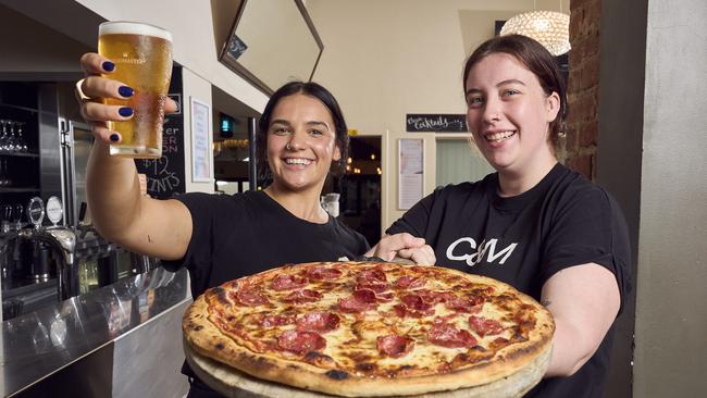 Queen’s Head Hotel staff Jemima Richter and Emily Baryczka-Quick with beer and pizza. Picture: Matt Loxton