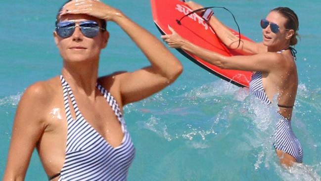 Heidi Klum shows off her supermodel curves while bodyboarding in the Caribbean.