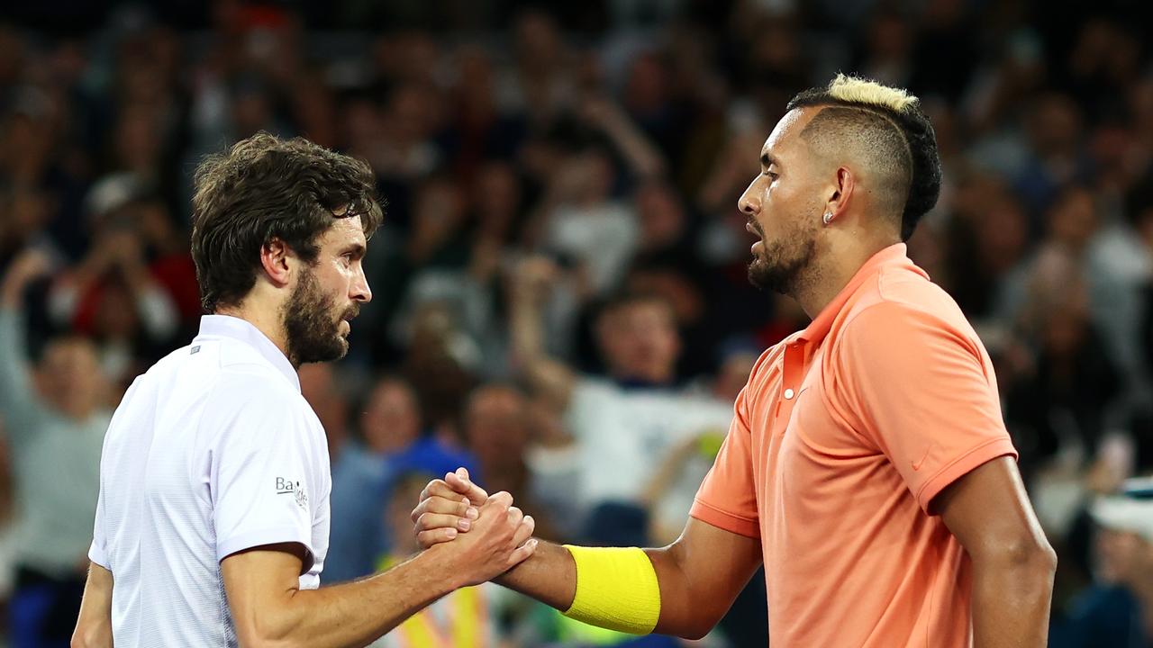 Nick Kyrgios shakes hands with Giles Simon after their second round match.